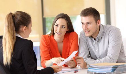 Learn More About Renters Insurance couple and agent discussing the terms