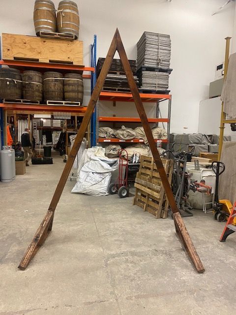 A large wooden a frame is sitting in a warehouse.