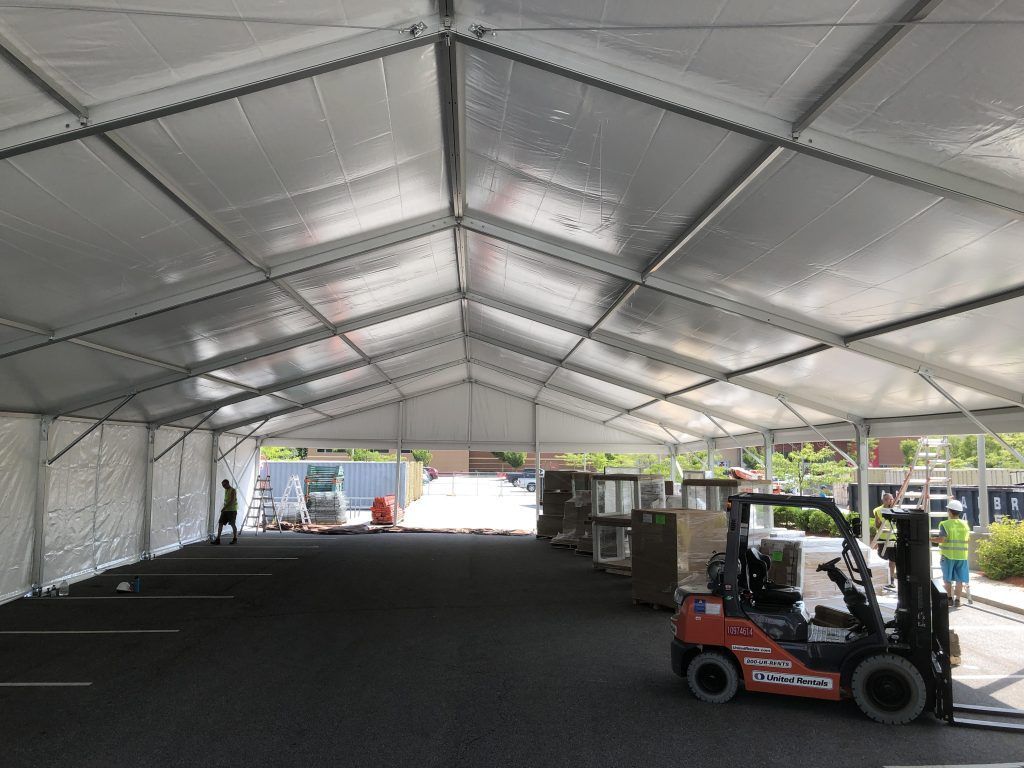 a forklift is parked inside of a large tent