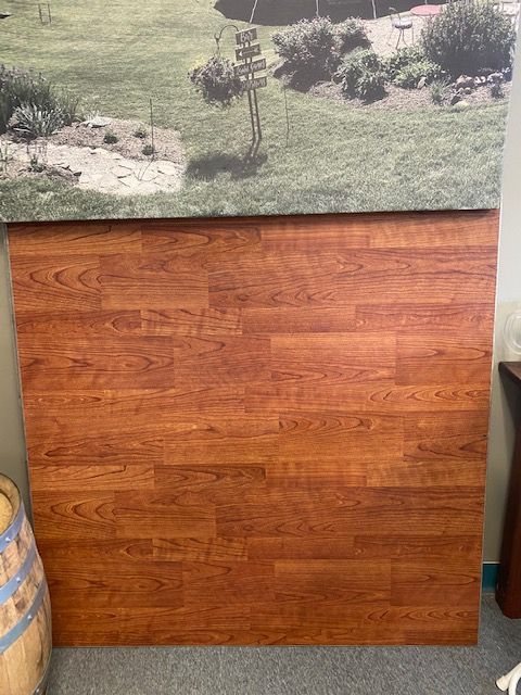 a wooden table with a picture of a field behind it