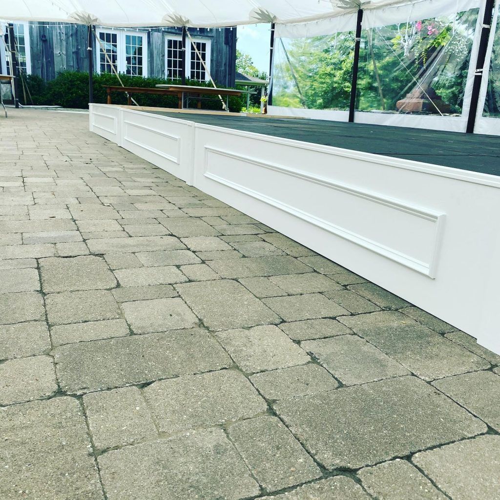 a brick walkway leading to a large tent