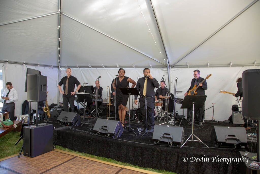 a band is playing on a stage in a tent