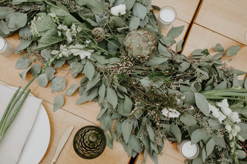 a table with plates , candles , and flowers on it