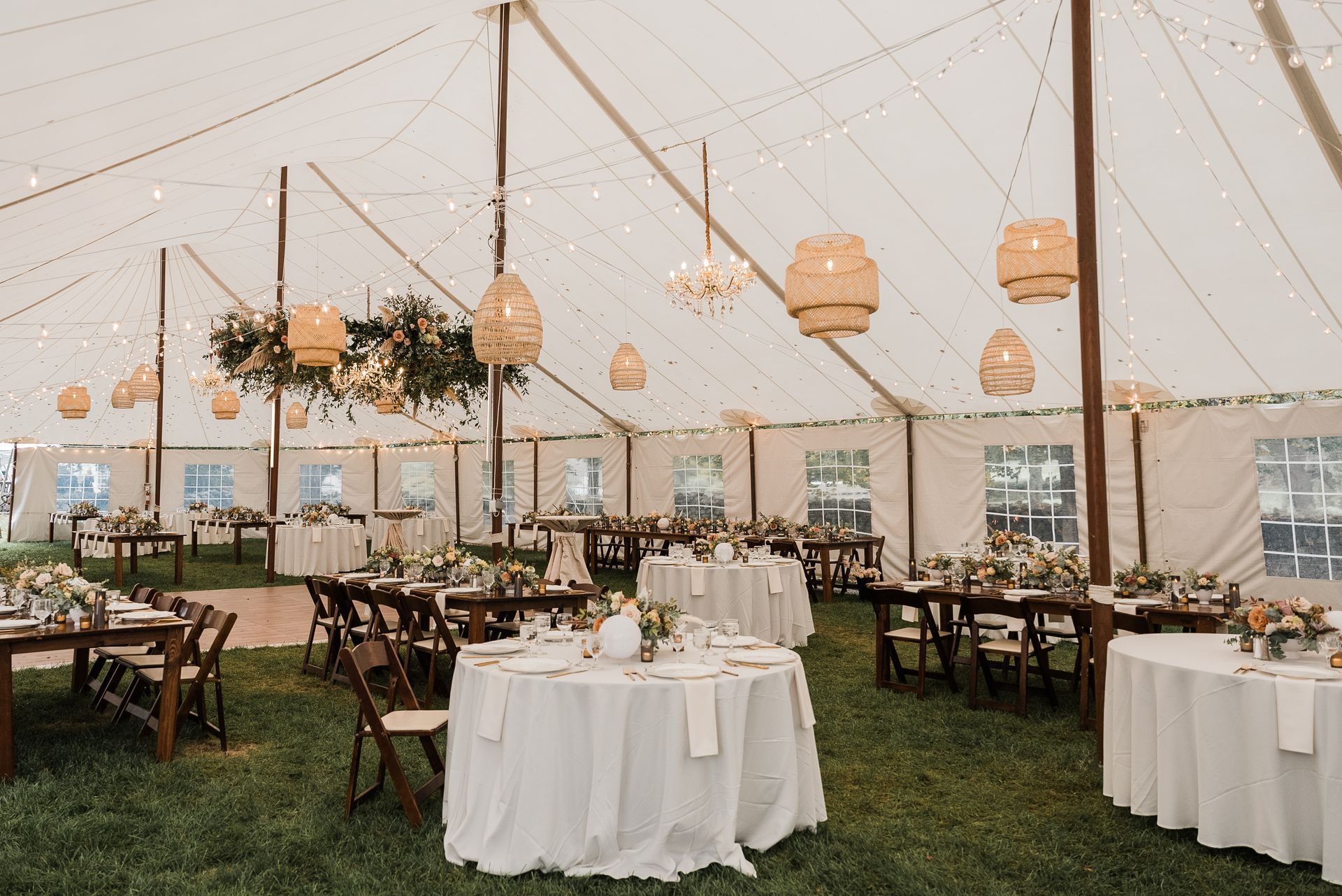 a large tent with tables and chairs set up for a wedding reception
