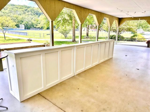 there is a long white bar in the middle of the room