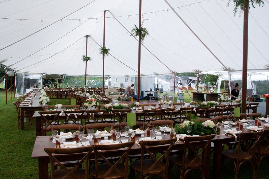a large tent with tables and chairs underneath it