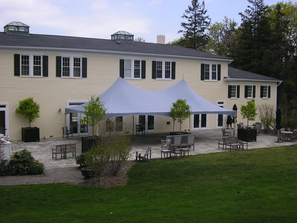 a large house with a tent in front of it