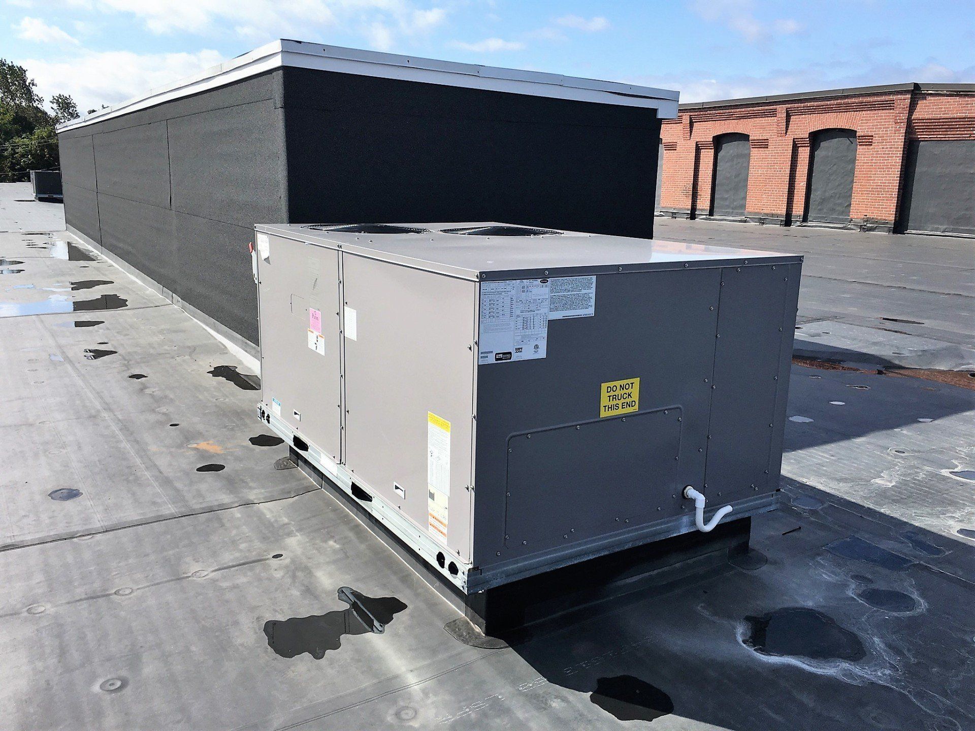 A large box is sitting on top of a roof.