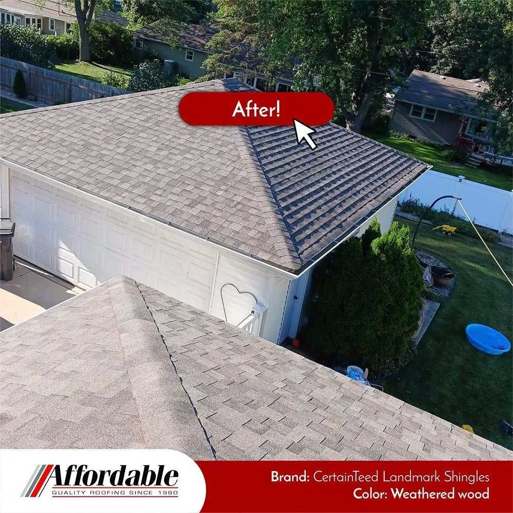 New roof on a house, gray shingles. Sign says