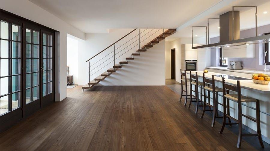 A kitchen with a staircase leading up to the second floor