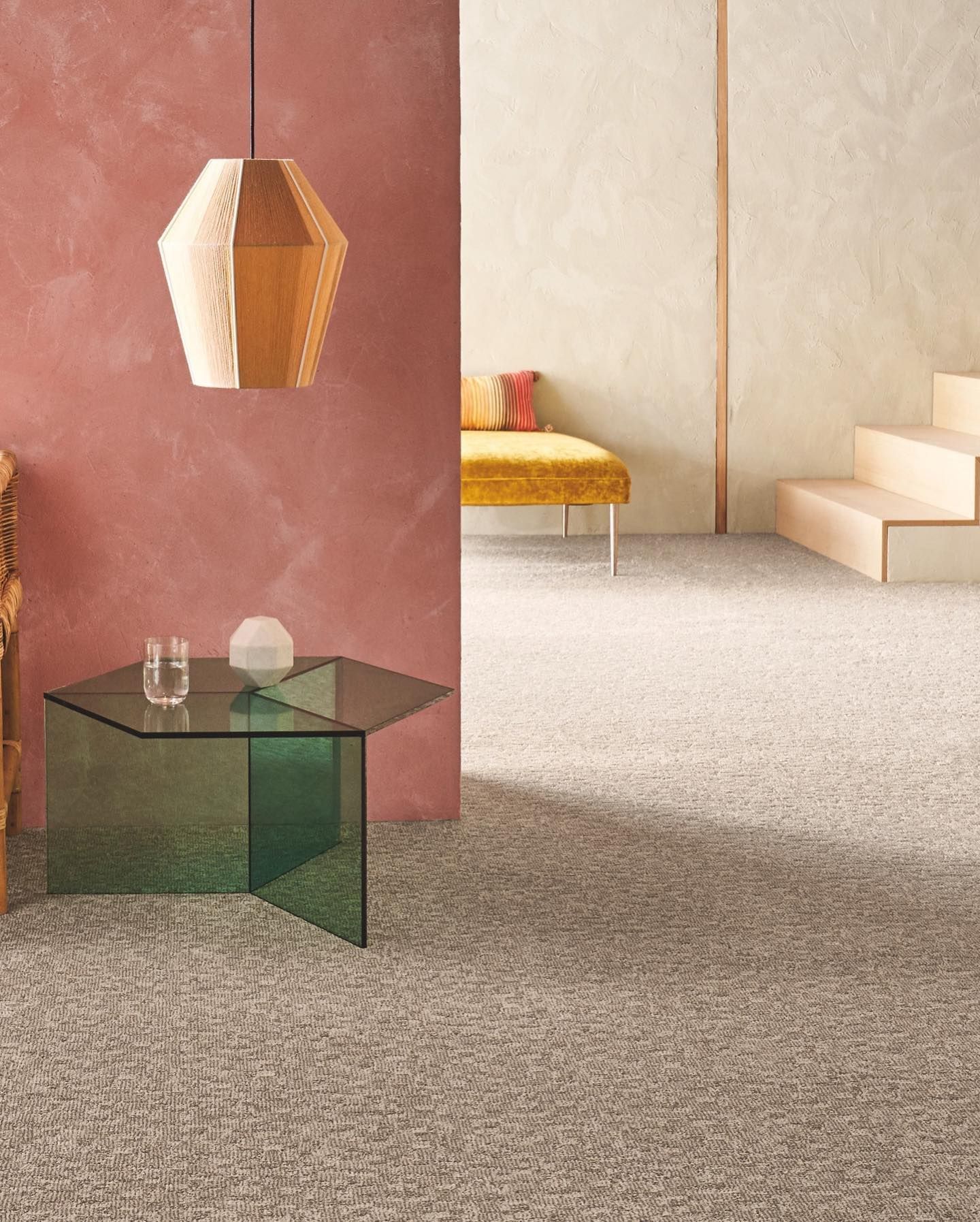 A living room with a glass table and stairs