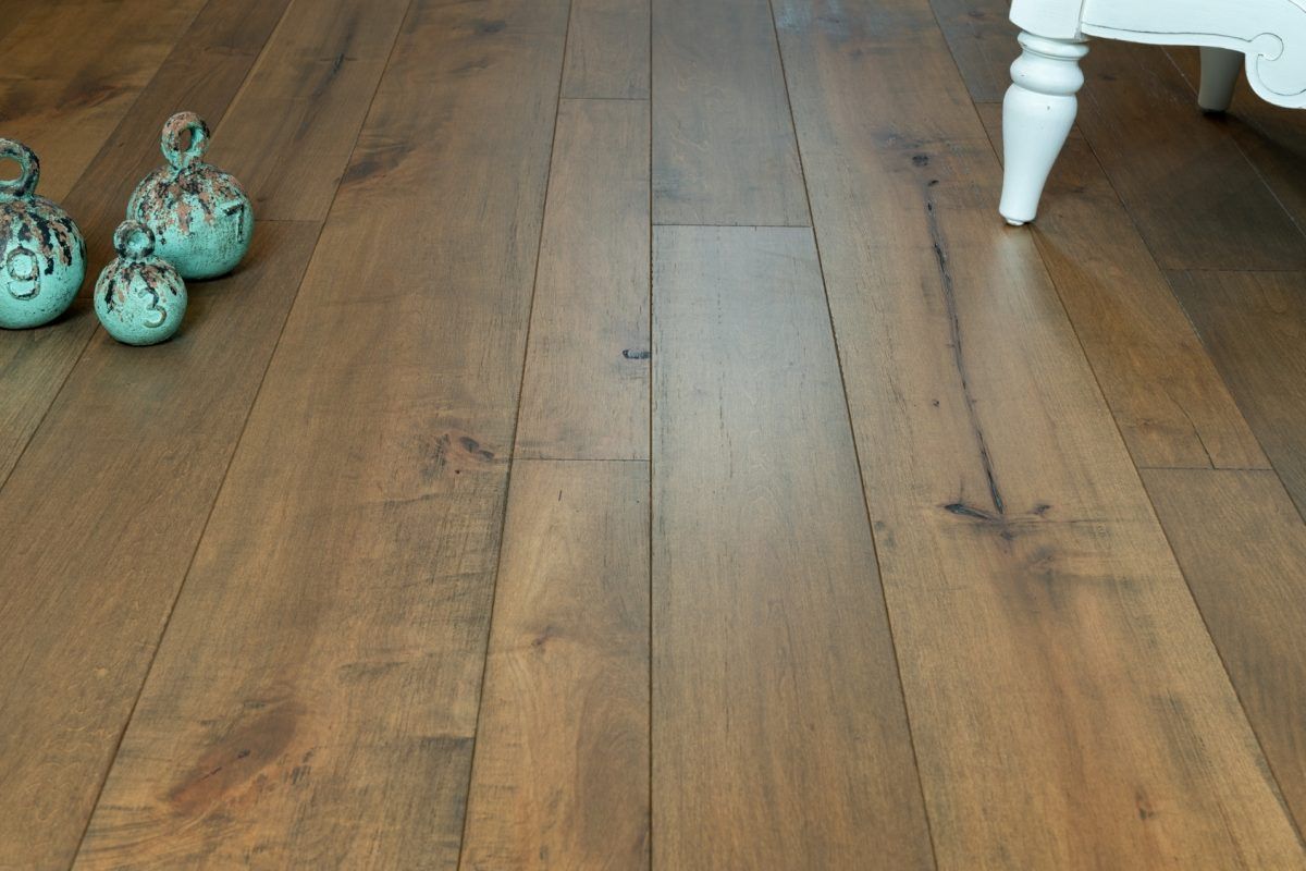 A wooden floor with a chair and vases on it