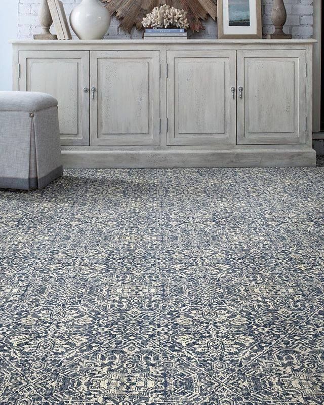 A living room with a rug and a dresser