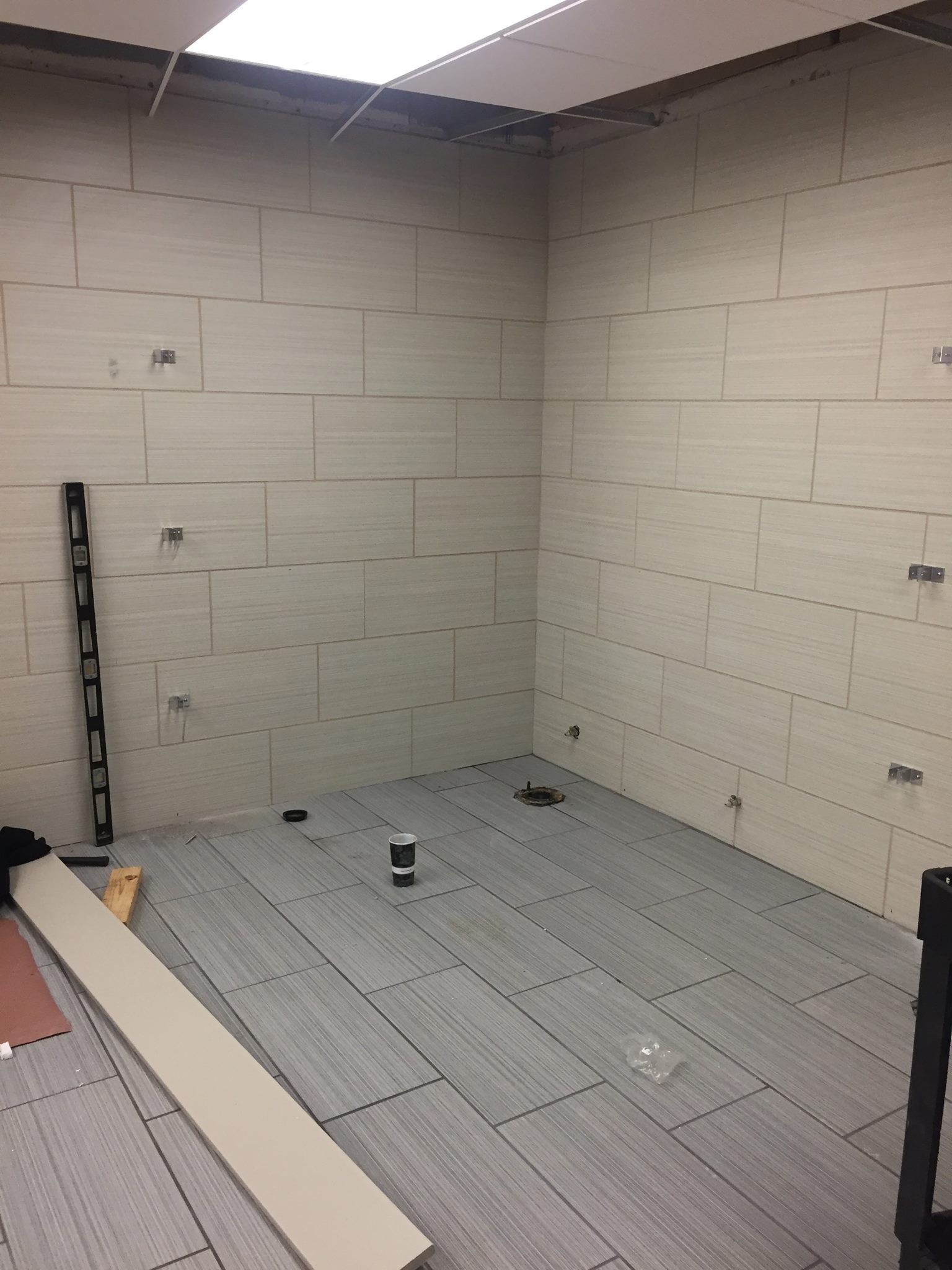 A room with a brick wall and a tiled floor.