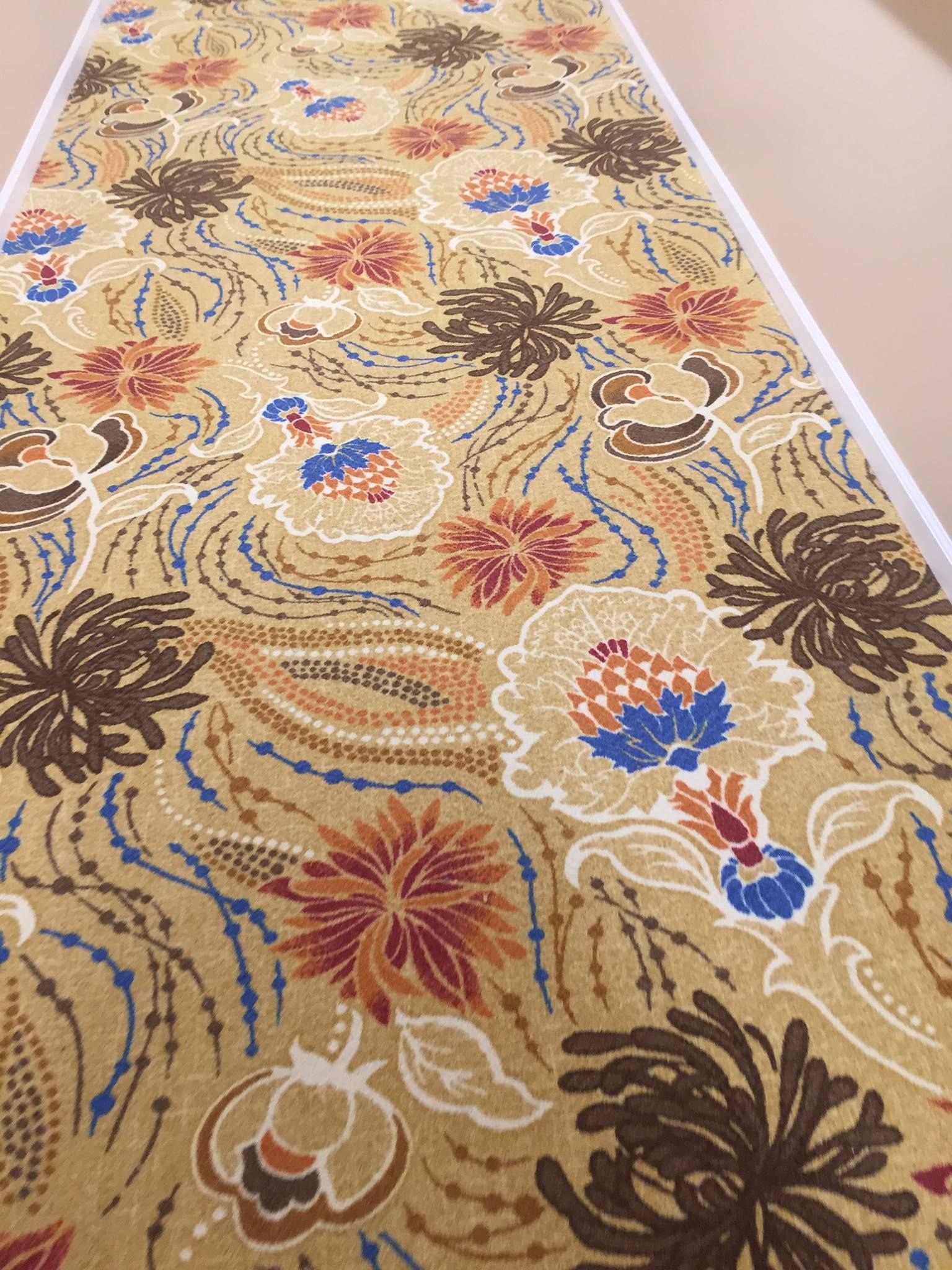 A carpet with a floral pattern on it is on the floor.