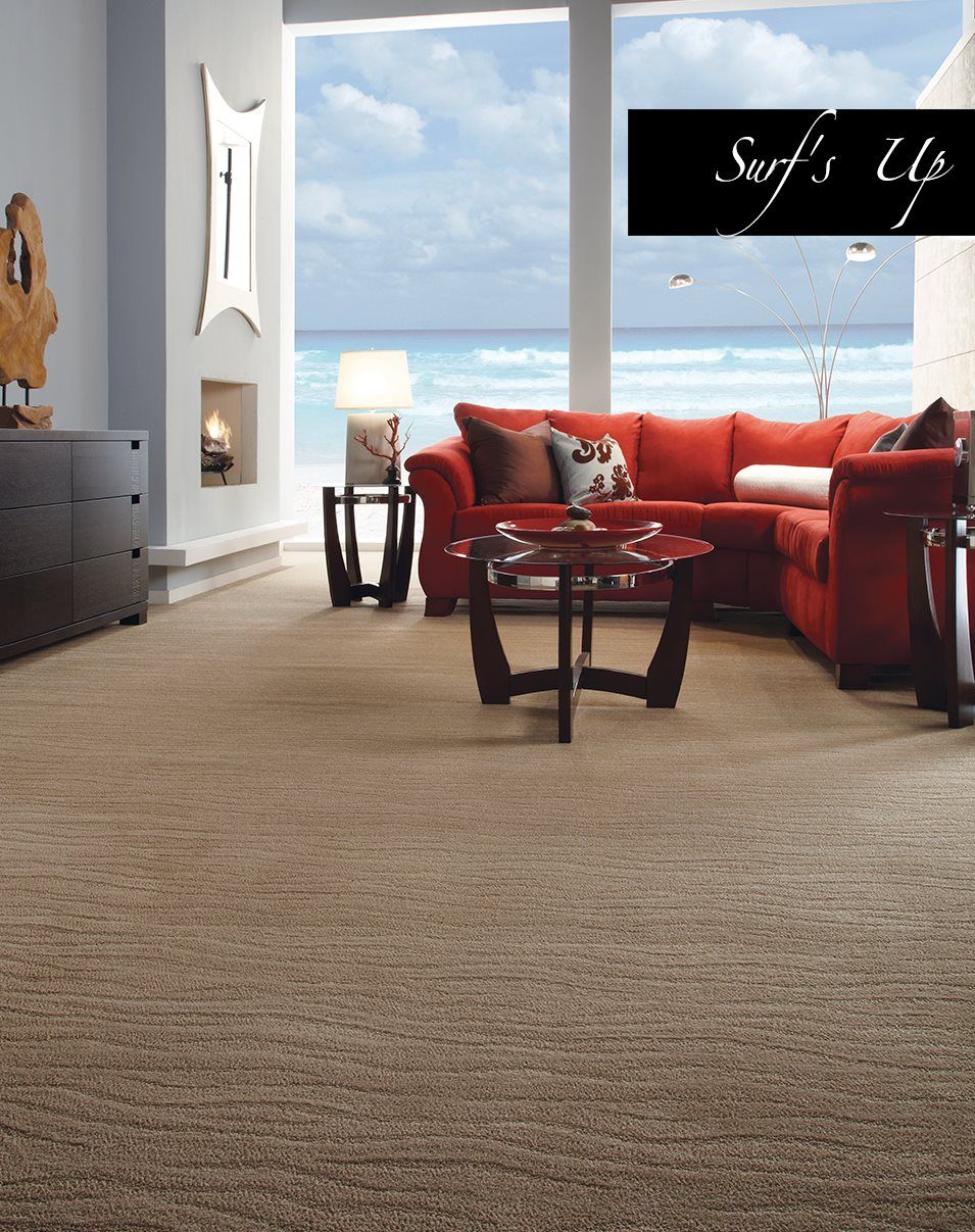 A living room with a red sectional couch and a glass coffee table