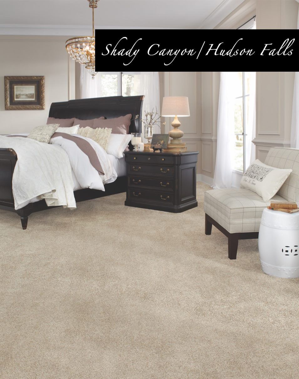 A bedroom with shady canyon carpet and a bed