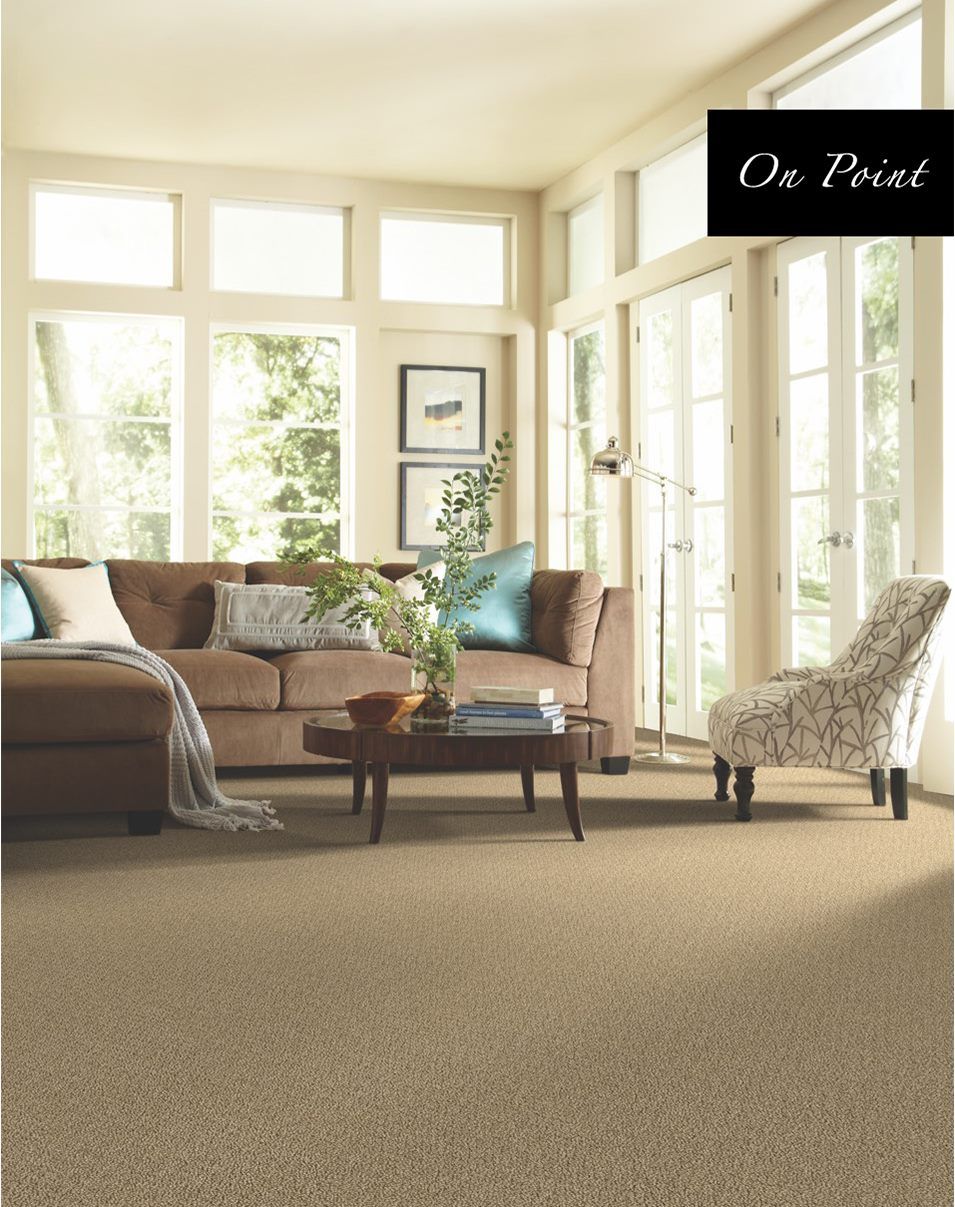 A living room with a couch a chair and a coffee table