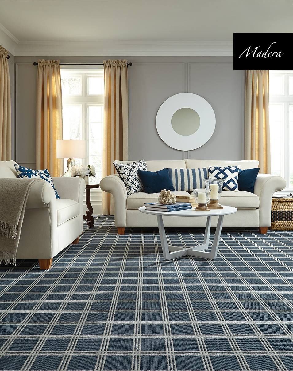 A living room with a couch, chair, table and rug