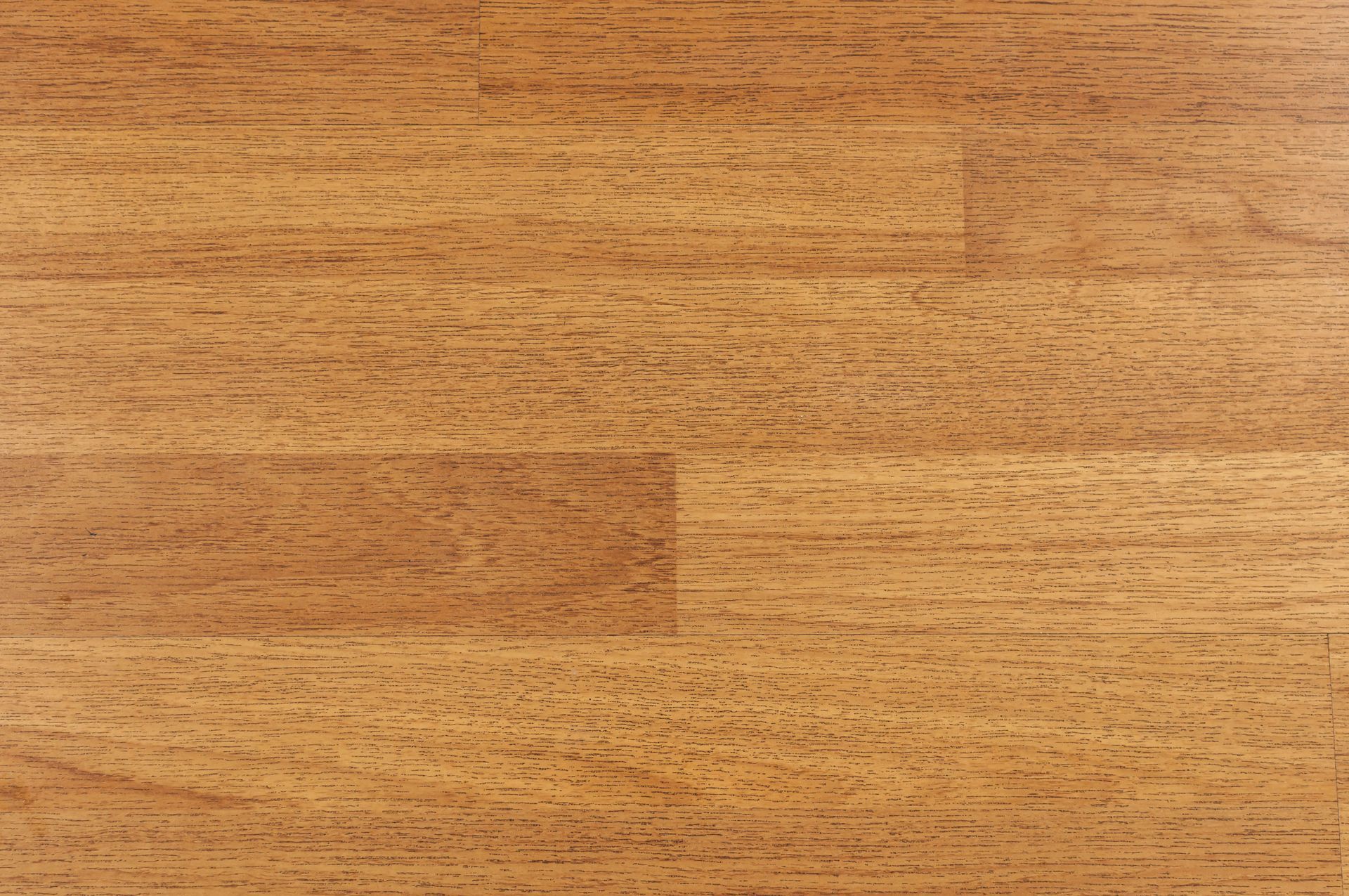 Wooden floor with a warm, light brown tone and visible grain texture.