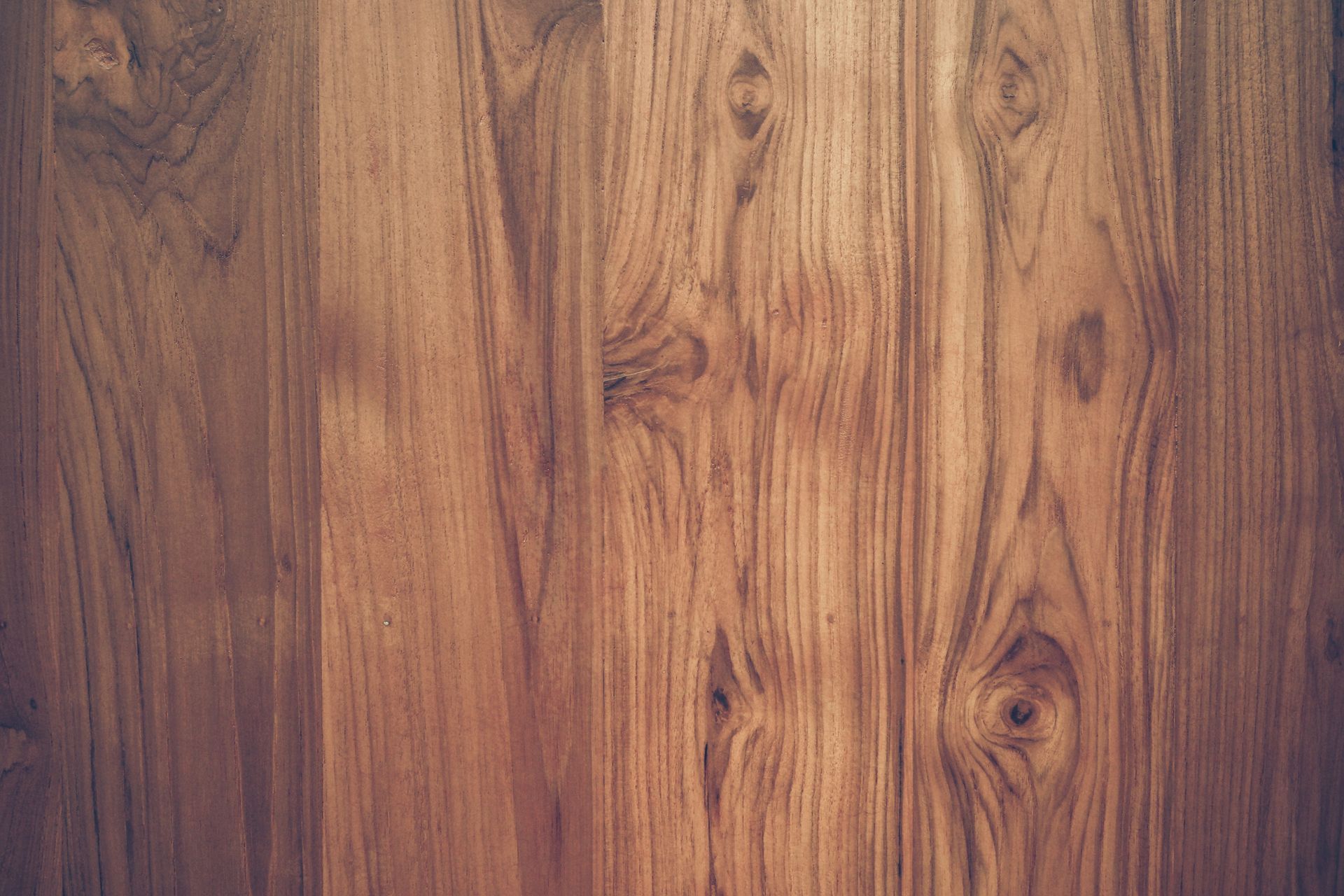 Wood grain background, vertical planks in varying shades of brown. Knots and natural patterns visible.