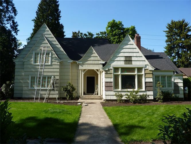 A white house with a ladder in front of it