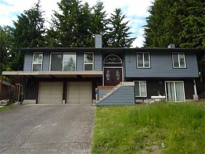 A large house with stairs leading up to the front door