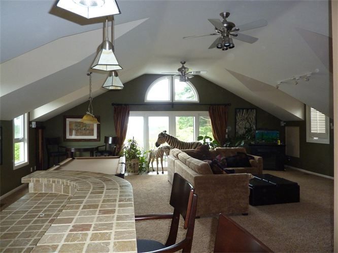A living room with a horse statue on the ceiling