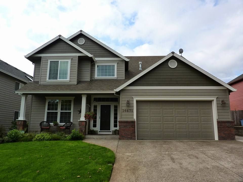 A large house with a garage and a lawn in front of it