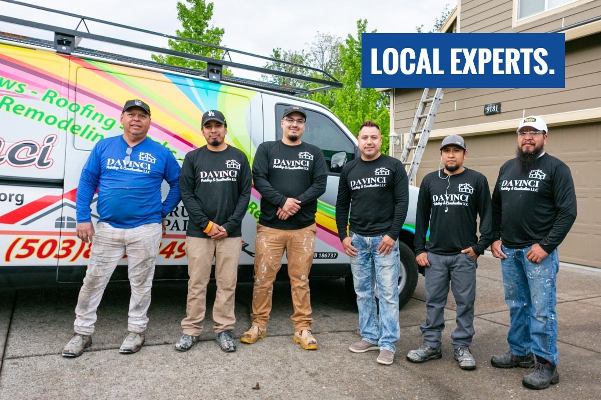 A group of men are posing for a picture in front of a truck.