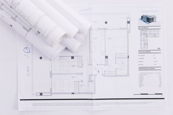 Printing press in operation; colorful paper sheets moving along rollers.