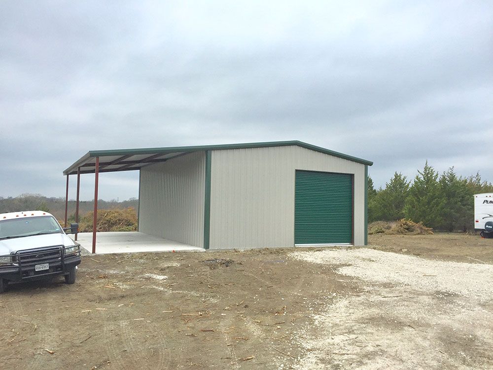 A white van is parked in front of a garage with a green door.