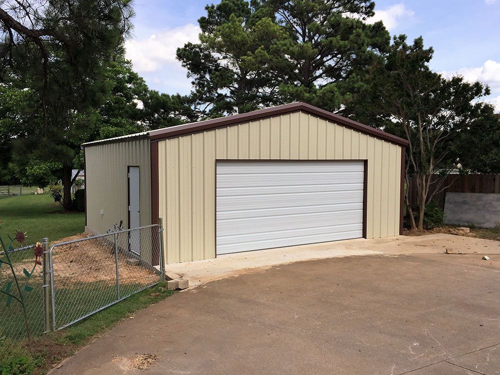 A garage with a white door and a brown roof