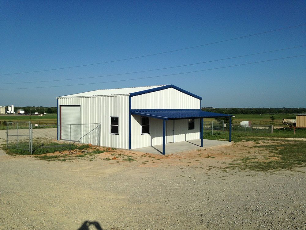 A white building with a blue roof and a porch