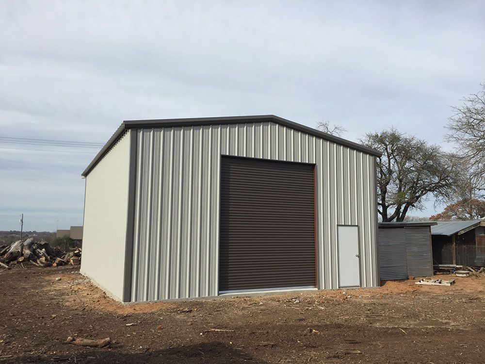 A metal building with a brown door and a white door