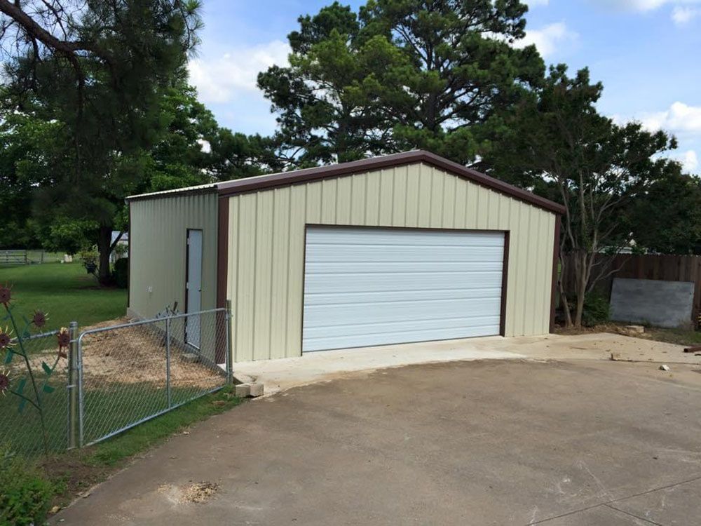 A garage with a white door and a brown roof