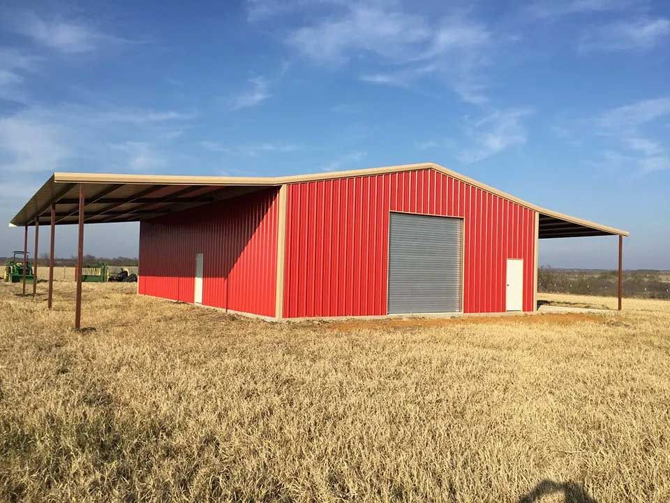 A red barn is sitting in the middle of a field.