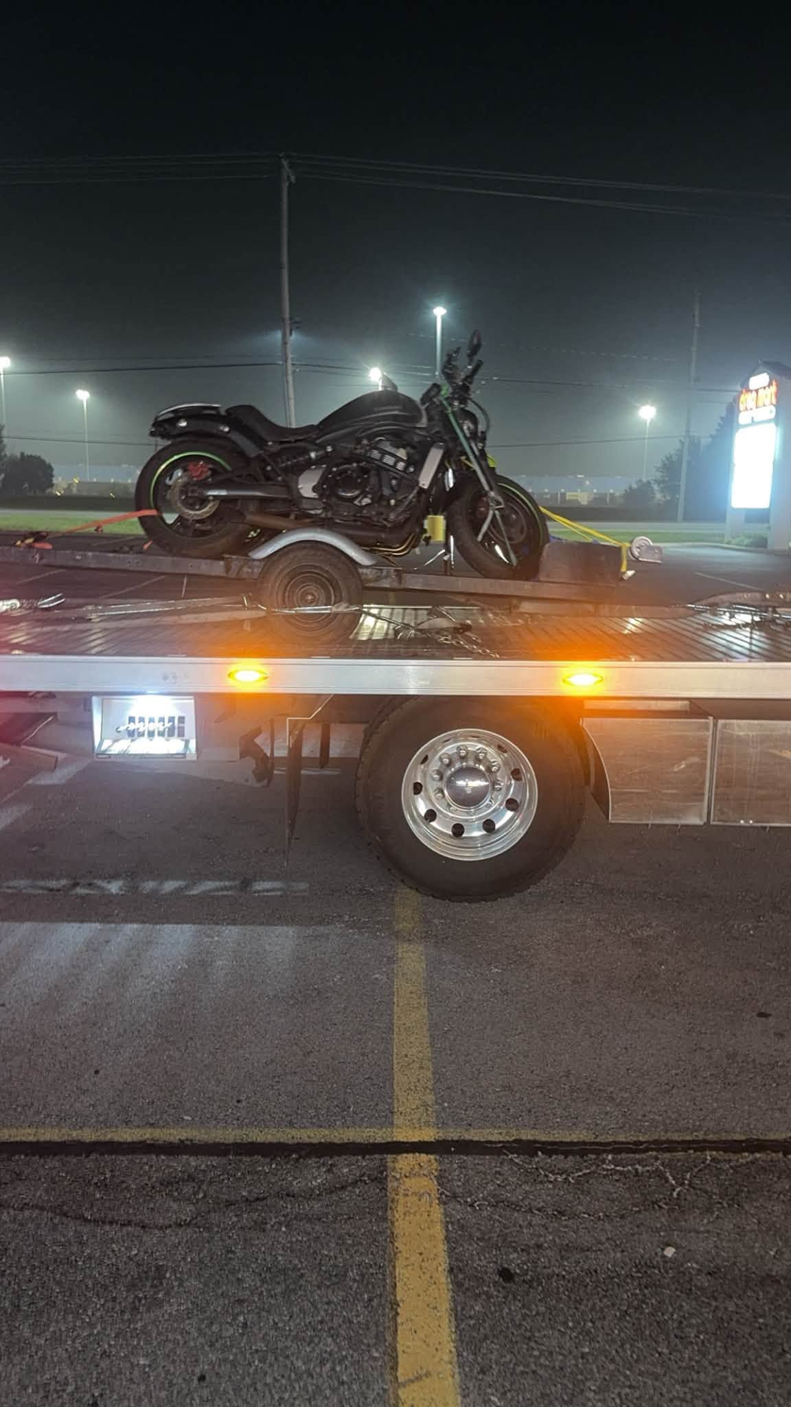 Wrecked motorcycle loaded on a tow truck