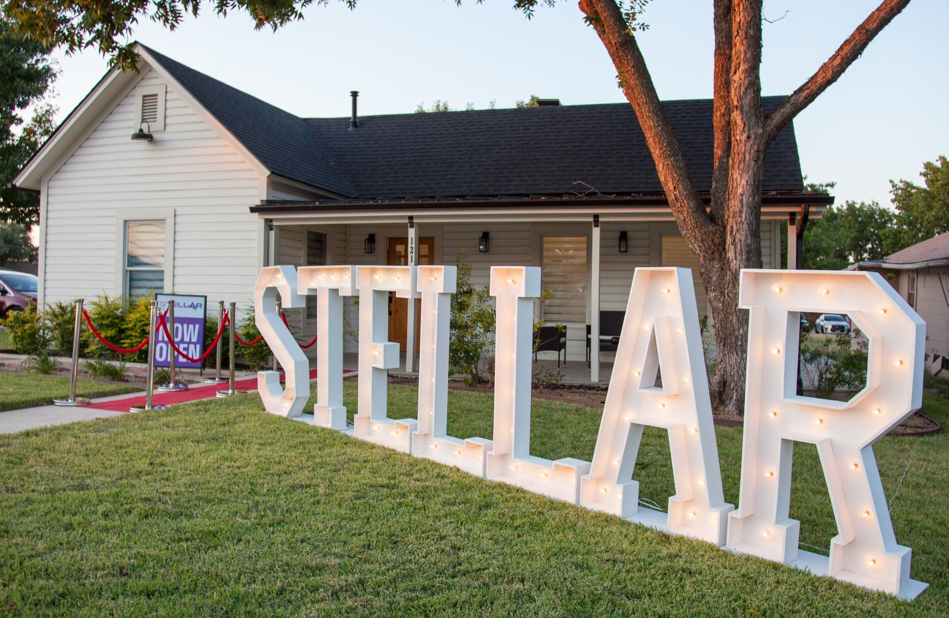 A white house with a sign that says Stellar in front of it.