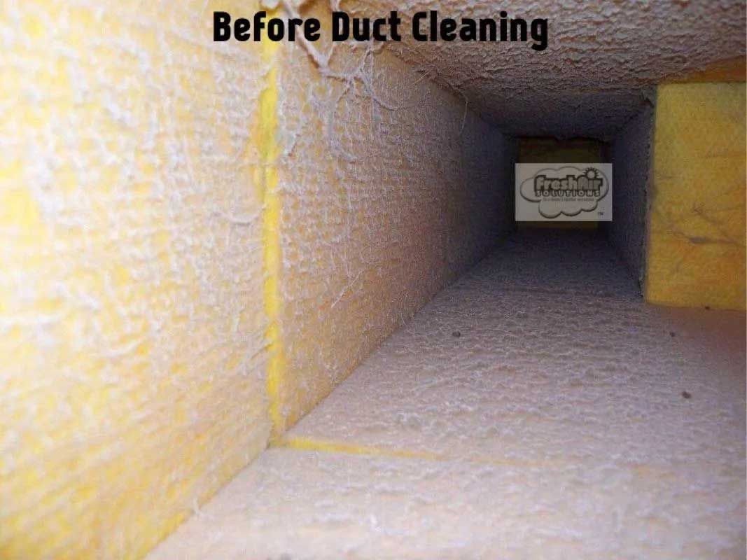 Dirty air duct interior before cleaning, coated in dust and debris.