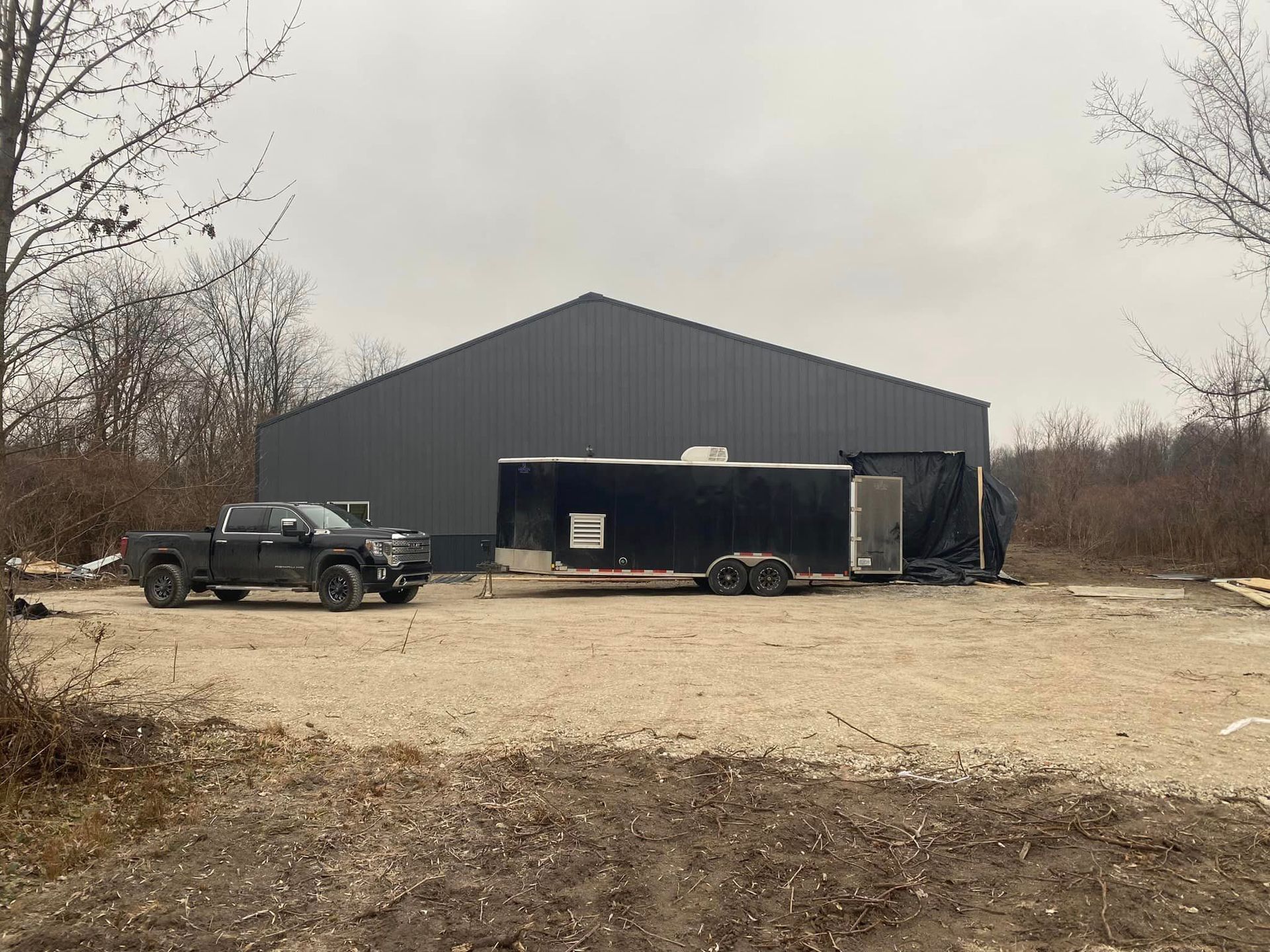 a truck and trailer are parked in front of a large building