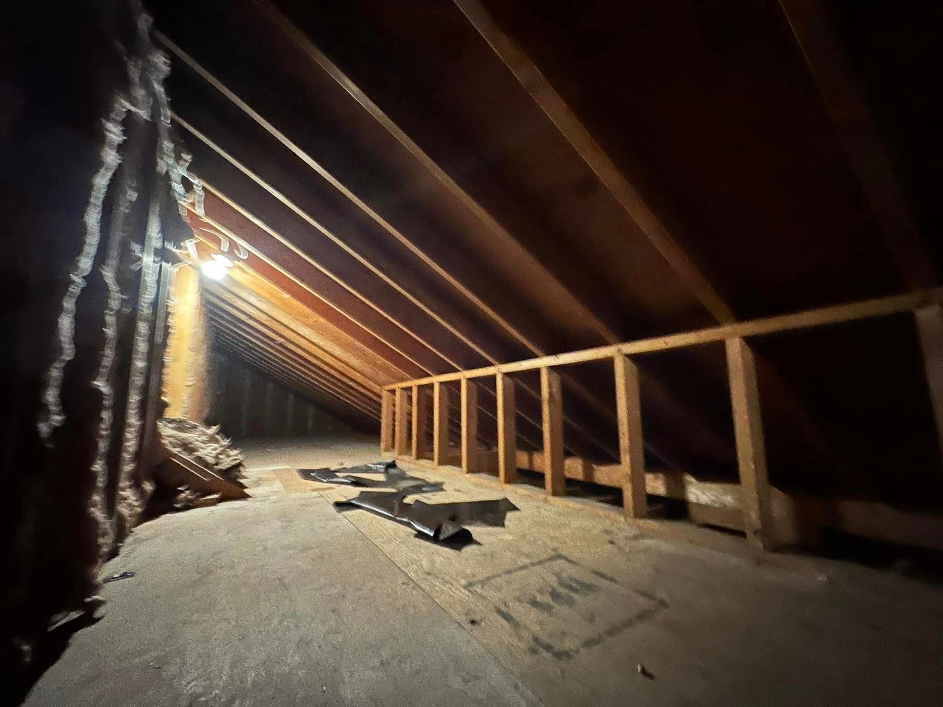 a dark attic with a light on the ceiling