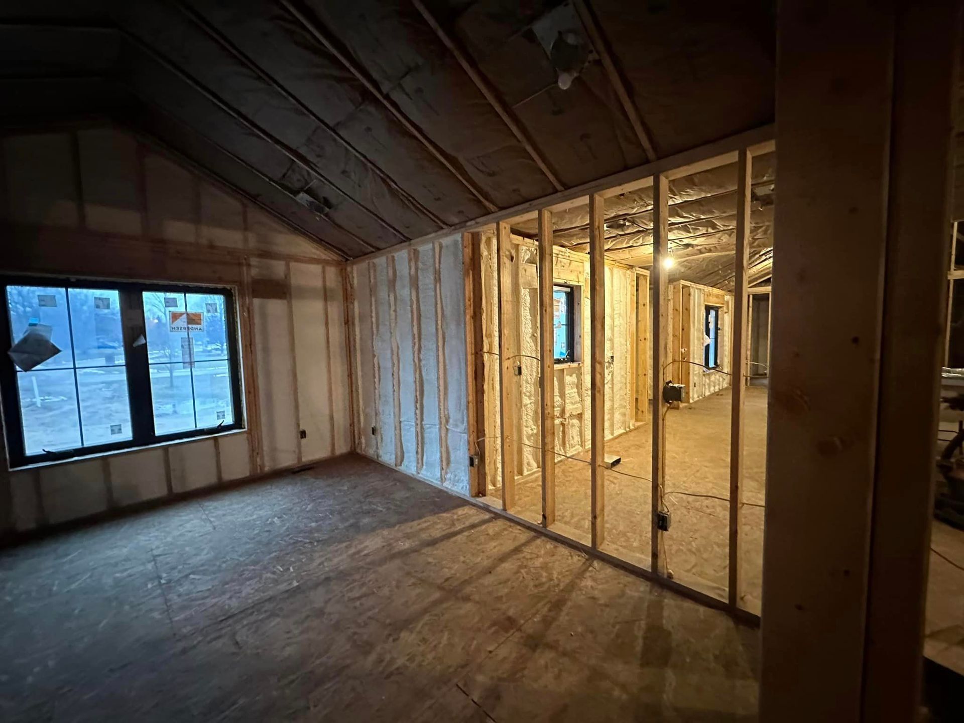 a room in a house under construction with a lot of windows