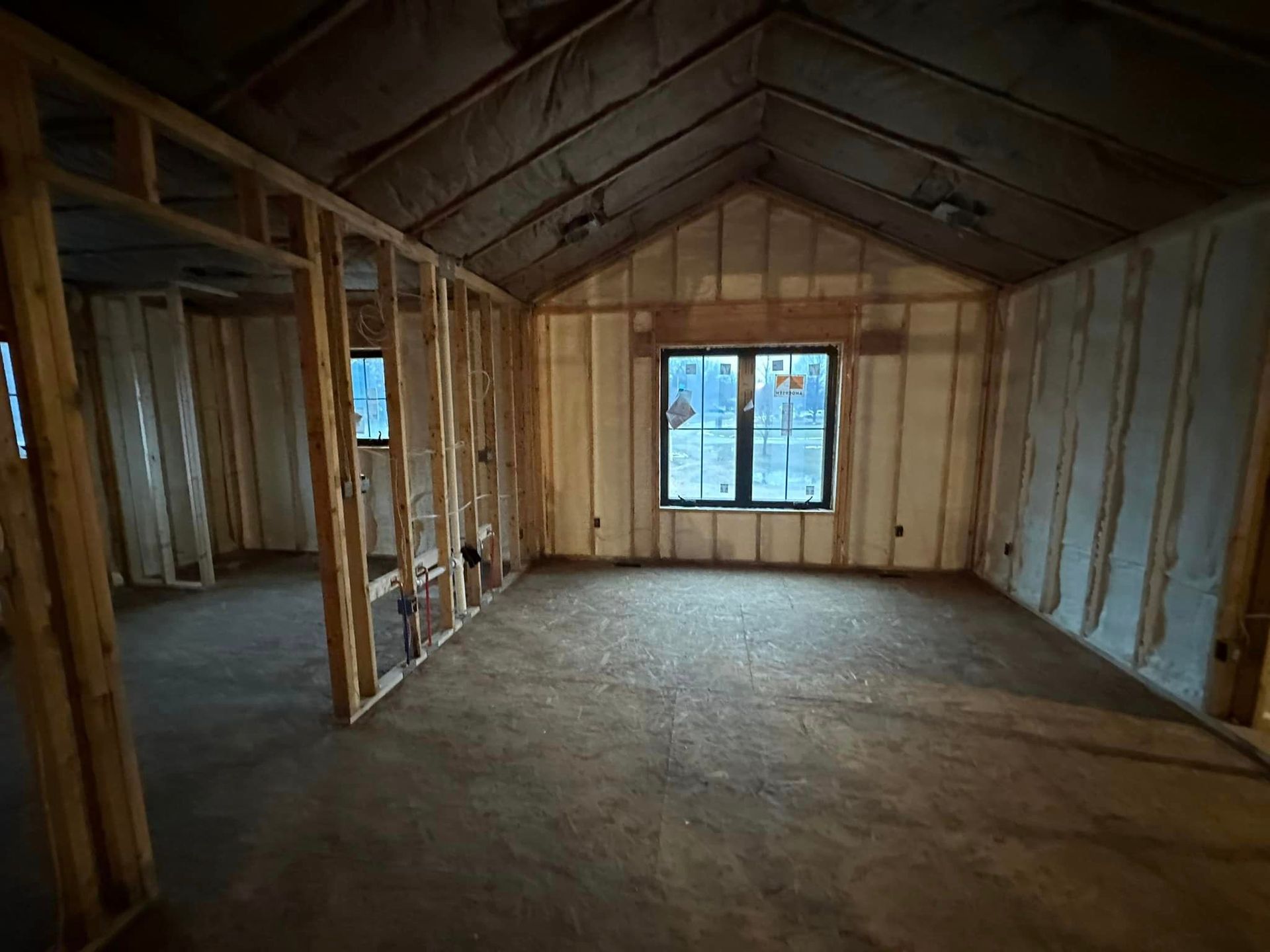 an empty room in a house under construction with insulation on the walls and ceiling