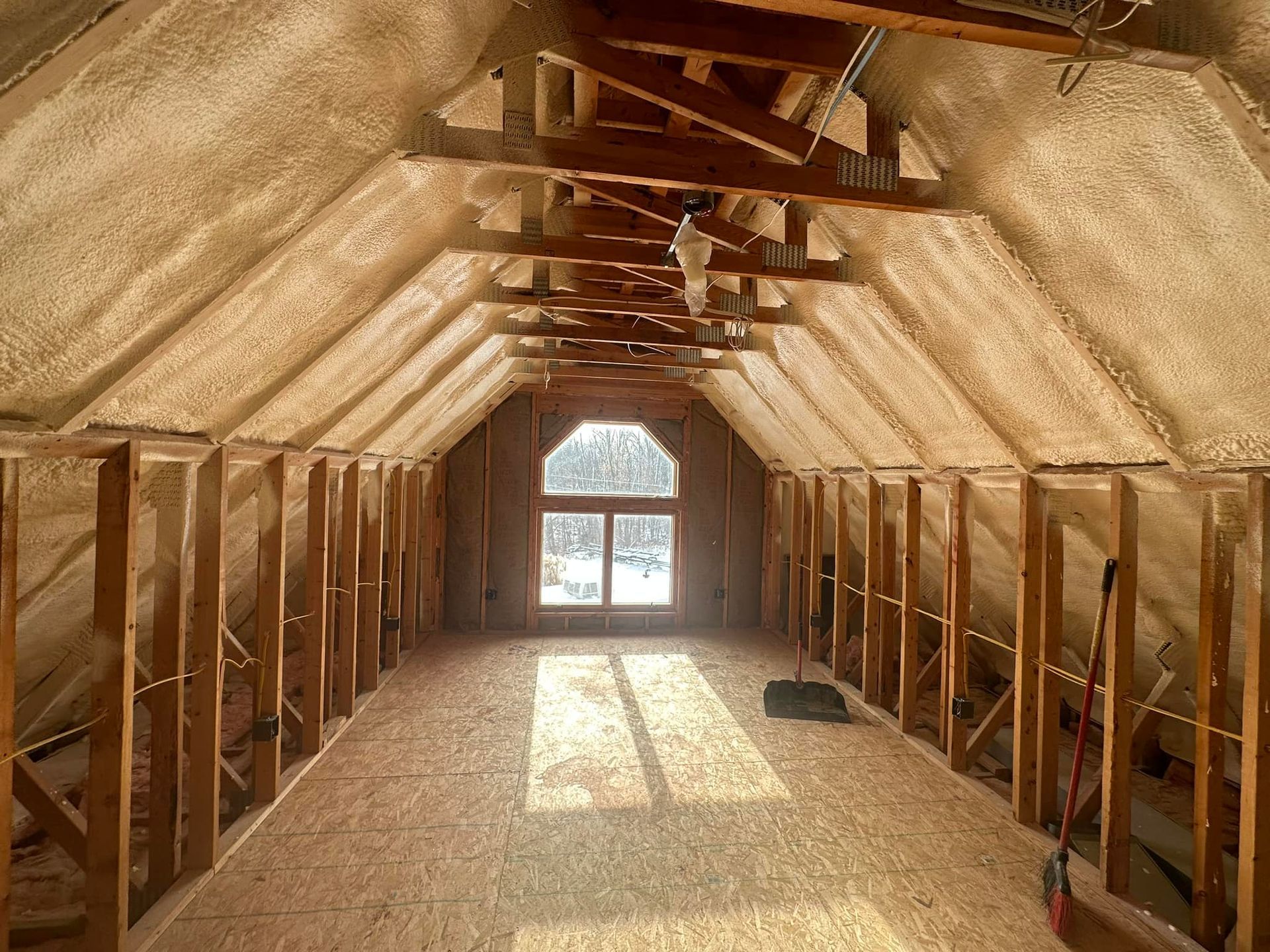 a room with a lot of wooden beams and a window