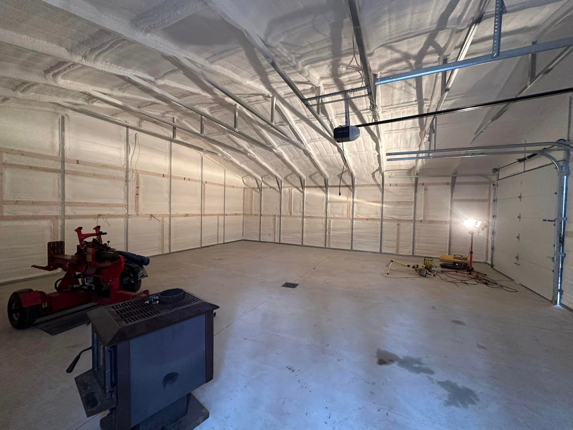 a large empty garage with a lot of insulation on the walls and ceiling
