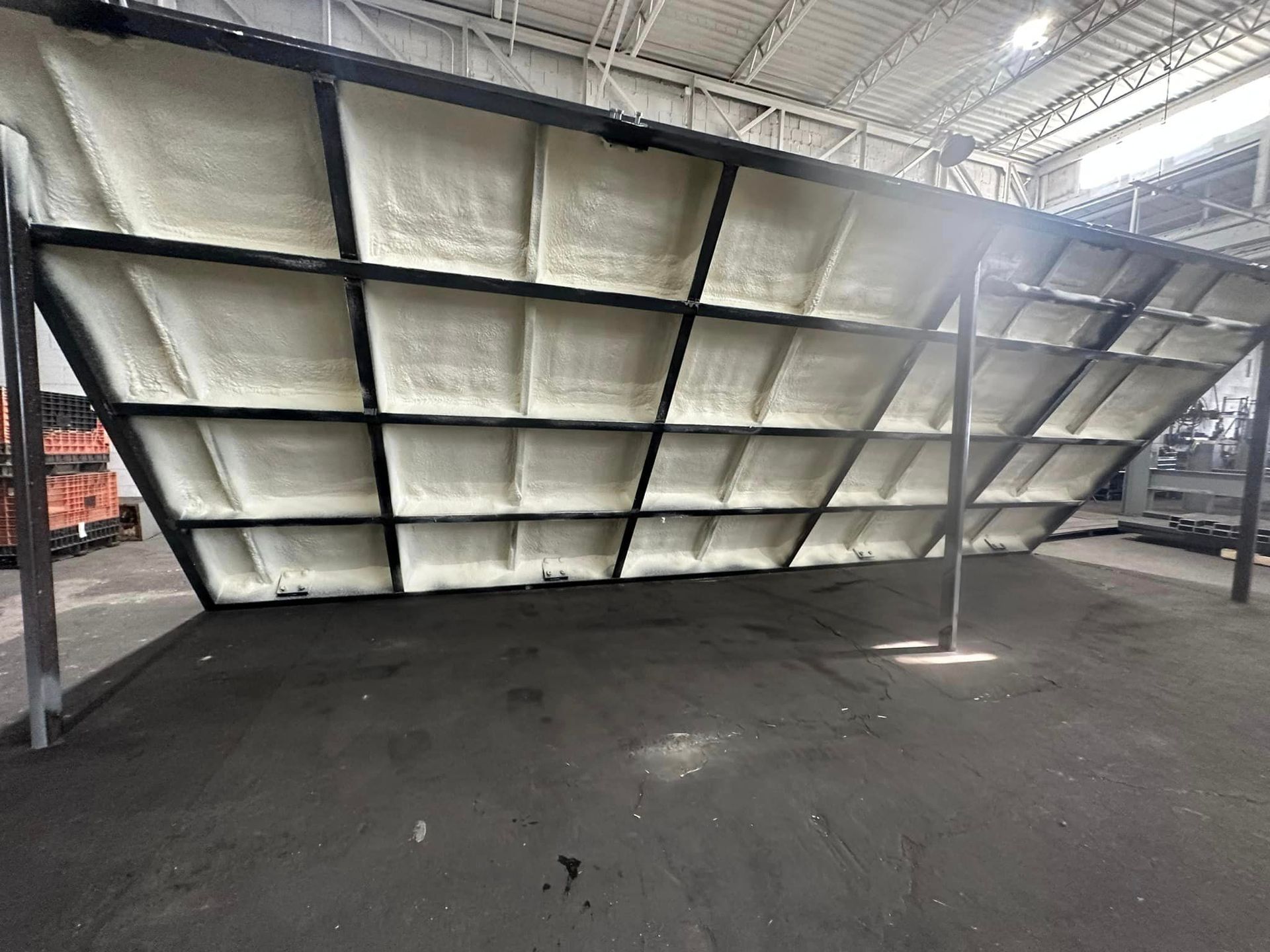 a large warehouse with a lot of shelves and a roof covered in foam