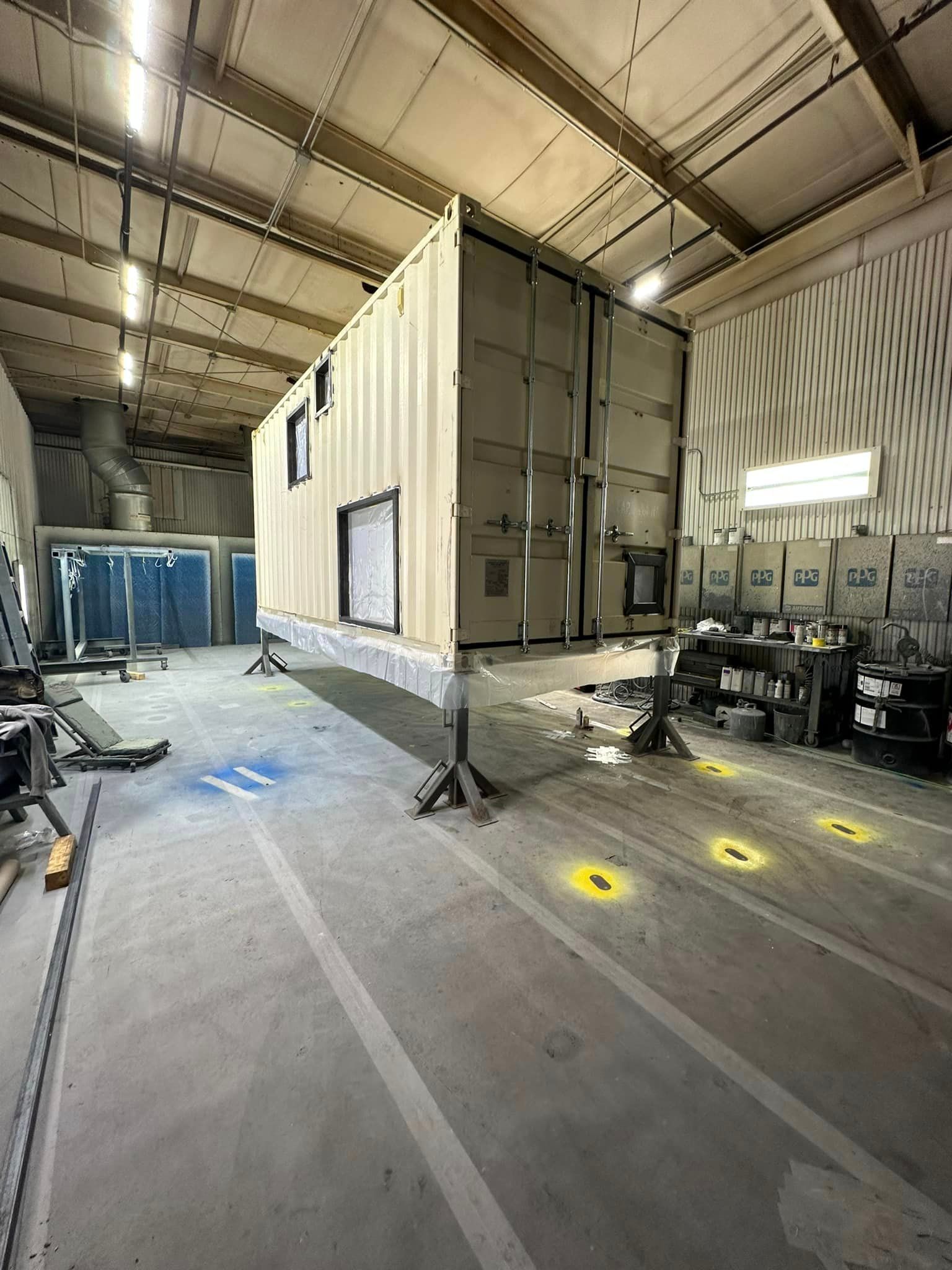 a large container is sitting on top of a concrete floor in a warehouse