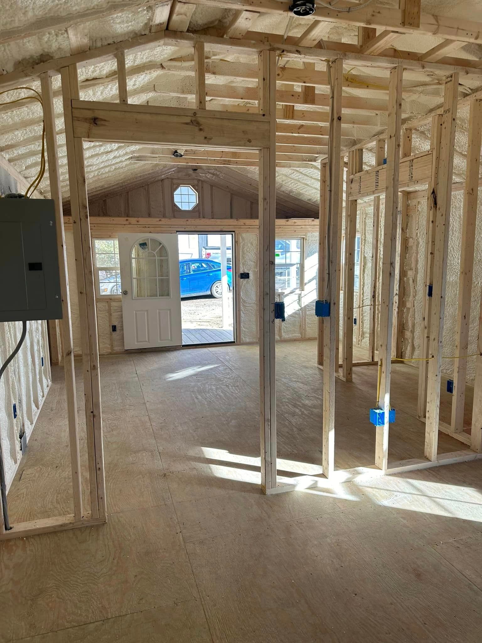 a room in a house under construction with a door and a window