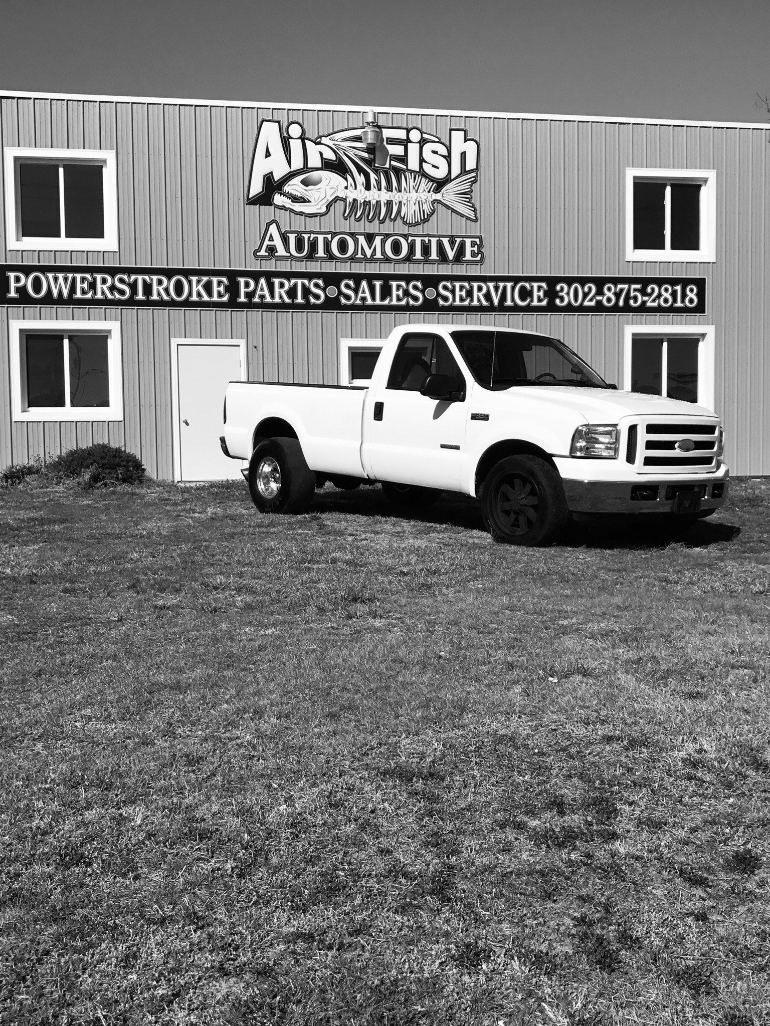 White pickup truck parked in front of 